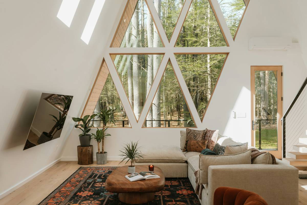 Side-by-side: left shows a rental with real local ceramics, weathered wood, and personal books; right shows identical layout with mass-produced decor, fake plants, and blank walls
